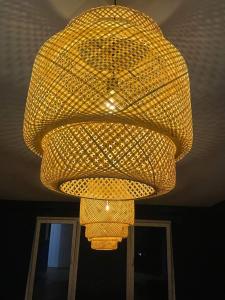 a large yellow chandelier hanging from a ceiling at The Blue House in Larnaka