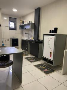 a kitchen with a white board on the floor at Flat JK 101 in Juazeiro do Norte