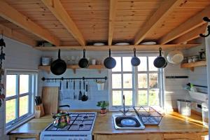a kitchen with a stove and some pots and pans at Tiny House on isolated farm by the Cornish Coast in Bude