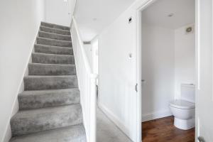 a staircase in a white room with a toilet at Castle Properties: The Duchess, 3 Bed Family cottage in Windsor +38 photos
