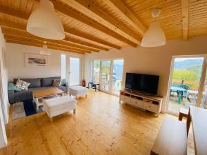 a living room with a couch and a tv at Chata Cérov in Púchov