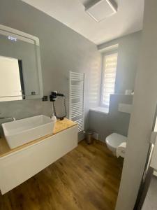 a bathroom with a white sink and a mirror at Penzion Puk 