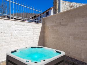 a hot tub sitting on the side of a building at Villa Lemily in Matulji