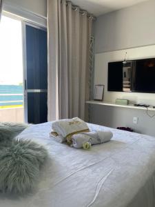 a bedroom with a bed with two pillows on it at Flat JK 203 in Juazeiro do Norte