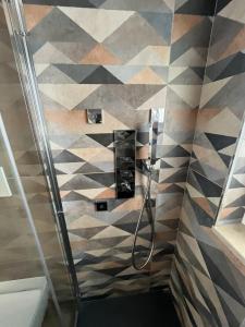 een badkamer met een douche met geometrische tegels bij Appartamento Mare Fuori in Polignano a Mare