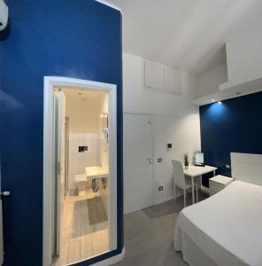 a bedroom with a bed and a bathroom with a sink at Boutique Rooms in Rome