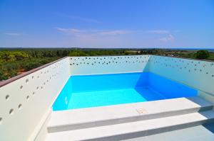 a view from the balcony of a house with a swimming pool at Boomerang Residence a Torre Colimena in Torre Colimena