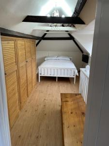 a bedroom with a bed and a chandelier at The Corner House, 36, Broadway Road, in Evesham