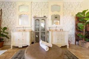 a room with two white cabinets and a table at Alphen Drive Apartments in Cape Town