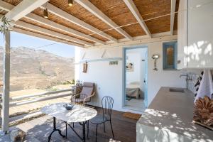 a kitchen and living room with a table and chairs at Foivos suite at Serifos in Serifos Chora