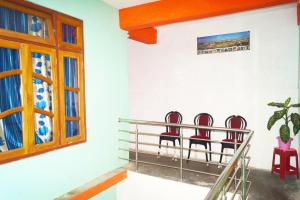 three chairs in a room with a window at Yumasham Camping in Darjeeling