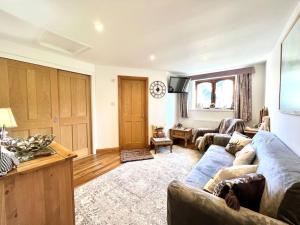 a living room with a couch and a table at Hectors House, Rothbury in Rothbury