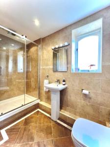 a bathroom with a sink and a shower and a toilet at Hectors House, Rothbury in Rothbury +18 photos