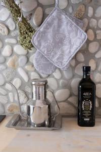a bottle of soap sitting next to a sink with a tea kettle at Pebbles Villa with private roof garden in Aliki