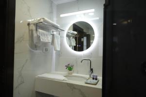 a white bathroom with a sink and a mirror at Mount of Olives Hotel in Jerusalem