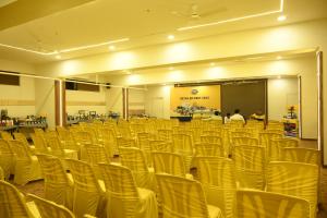 a room with rows of chairs in a hall at HOTEL CENTER POINT in Solapur