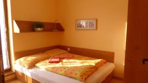 a bedroom with a bed with a blanket on it at Apartmán Oščadnica in Oščadnica