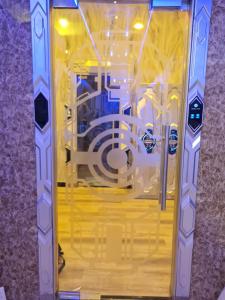 a glass door with a spiraligunigunigunigunigunigunigunigunigunigun at Capsule Riverside in Ho Chi Minh City