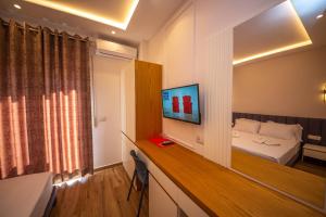 una camera d'albergo con letto e TV di Hotel Vila Misiri a Durrës