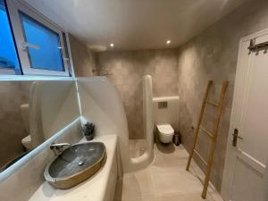 a bathroom with a sink and a toilet at Simousea in Kithnos +32 photos
