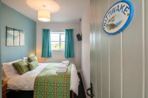 a bedroom with a bed and a sign on the wall at East Trewent Farm in Pembroke