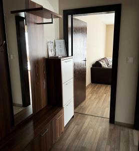 a room with a mirror and a dresser and a couch at Lubata 5 Apartments - 2 bedrooms in Sofia