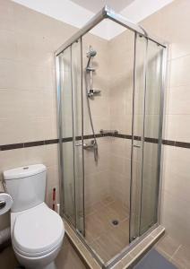 a shower stall in a bathroom with a toilet at Lubata 5 Apartments - 2 bedrooms in Sofia