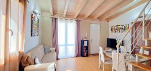 a living room with a couch and a desk and a television at Villa MiraMar Luxury Suite Palermo Airport in Carini +15 photos