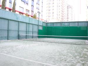 a tennis court in a city with tall buildings at The Great Valencia Stay in Valencia