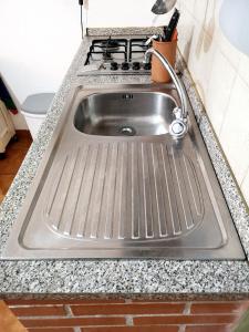 a stainless steel sink in a kitchen with a stove at Casa vacanze La Marinella in SantʼEufemia Lamezia