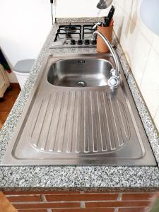 a stainless steel sink in a kitchen with a stove at Casa vacanze Marinella in SantʼEufemia Lamezia