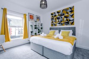 a bedroom with a large bed and a window at NEW! Stylish 2-bed home, in Chester by 53 Degrees Property, Ideal for Long Stays, Great location - Sleeps 6 in Chester