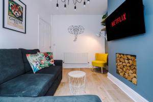 a living room with a couch and a fire place at NEW! Stylish 2-bed home, in Chester by 53 Degrees Property, Ideal for Long Stays, Great location - Sleeps 6 in Chester