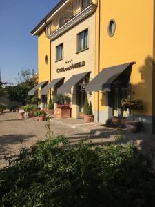 a yellow building with umbrellas in front of it at Hotel Casal Dell'Angelo in Marigliano