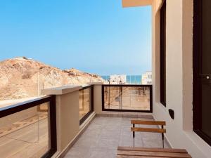 a balcony with a bench and a view of a mountain at ONE 2BHK Apartments in Muscat