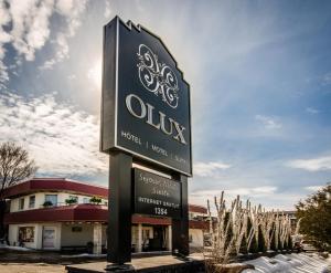 a sign in front of a building at Olux Hotel-Motel-Suites in Laval