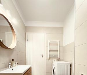 a white bathroom with a toilet and a sink at The Palm 2 Apartment - family friendly, central, self check-in in Oradea +12 photos