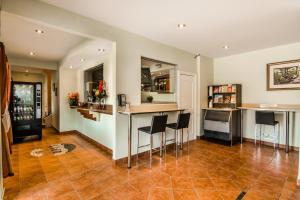 a kitchen with a bar with stools in it at Olux Hotel-Motel-Suites in Laval