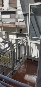 an empty room with a metal railing and a balcony at Romiti Apartment in Ferrara