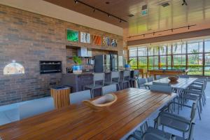 a dining room with a large wooden table and chairs at Reserva Sauípe - Casa 189 in Costa do Sauipe