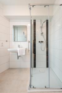 a bathroom with a glass shower and a sink at Hotel in Laisen in Reutlingen
