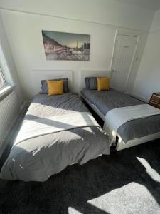 two beds sitting next to each other in a bedroom at Beck View House in Stockton-on-Tees