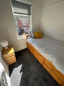 a small bedroom with a bed and a window at Beck View House in Stockton-on-Tees