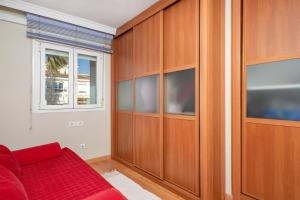 een woonkamer met een rode bank en een raam bij Penthouse with seaview by Costarentals - Ref 08 in Torremolinos