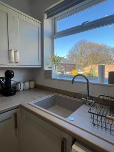 a kitchen with a sink and a large window at Beck View House in Stockton-on-Tees