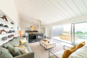 a living room with a couch and a fireplace at Casas da Prainha A in Prainha de Baixo