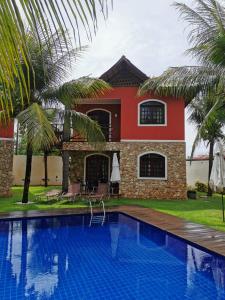 uma casa com piscina em frente a uma casa em Chale Canoa Quebrada La Fazenda em Canoa Quebrada