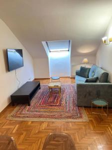 a living room with a couch and a table at Apartamento Bautista Centro in Cangas de Onís +29 photos