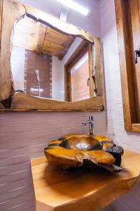 a bathroom with a large wooden sink with a mirror at Комплекс Конна база Асгард 