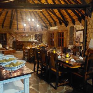 a restaurant with wooden tables and chairs and a dining room at Torgos Lodge in Koës